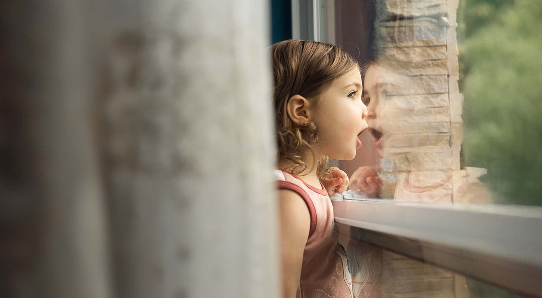 2025 May Activity Calendar hero with a girl looking out the window.