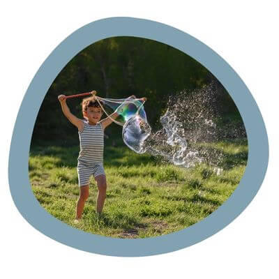 Child blowing giant Far Out Bubbles.