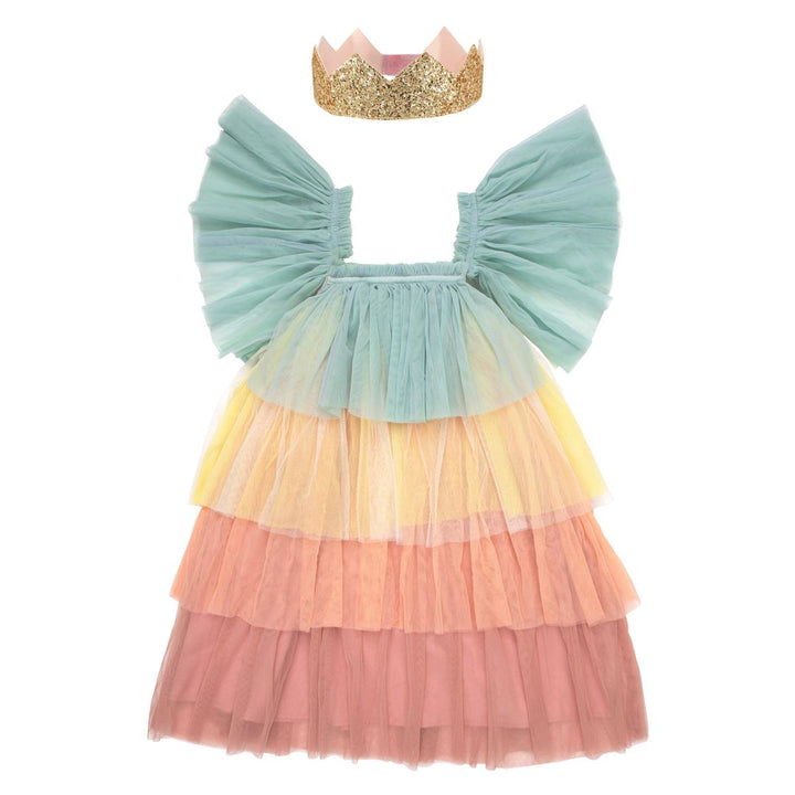 Children’s pastel Rainbow Ruffle Princess Costume Set featuring a rainbow tulle dress with large flutter sleeves and gold glitter crown from Meri Meri against a white background.