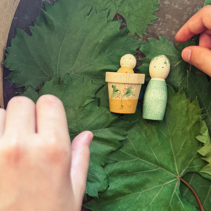 Grapat Lucky Lucky 5th Edition - image of wooden parts displayed on leaves with children's hands - Bella Luna Toys