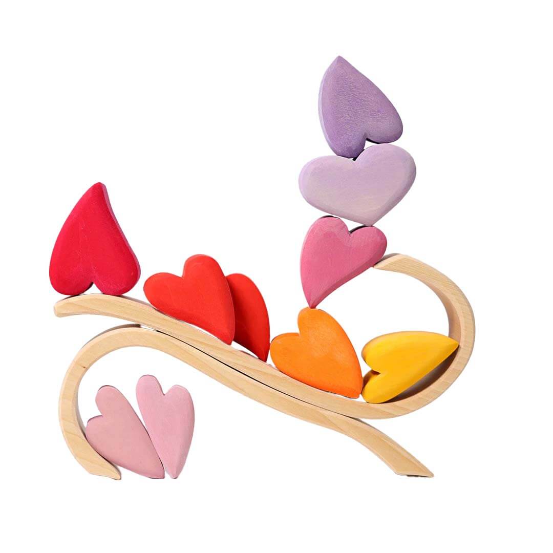 Colorful heart-shaped wooden toy on a white background.