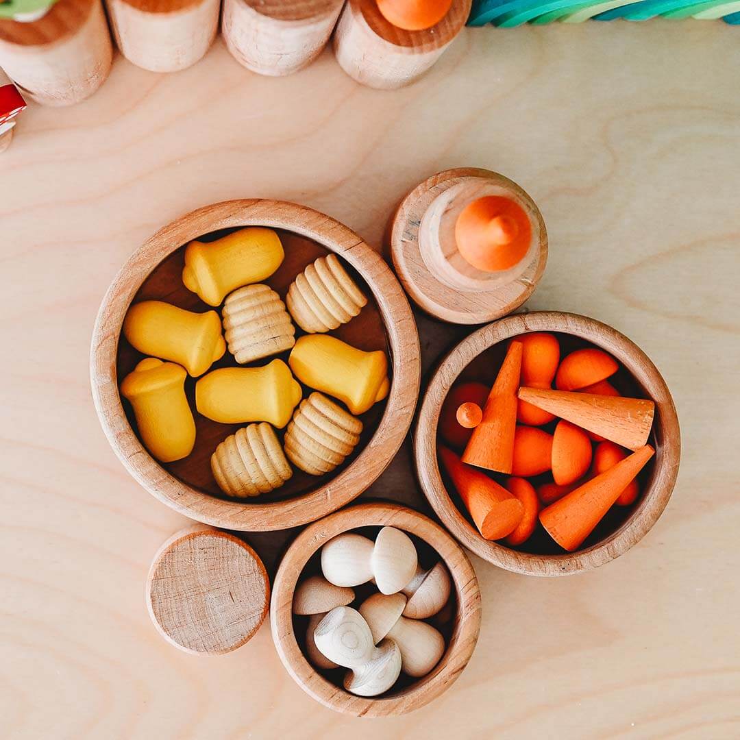 Wooden toy cones and blocks on a wooden surface.