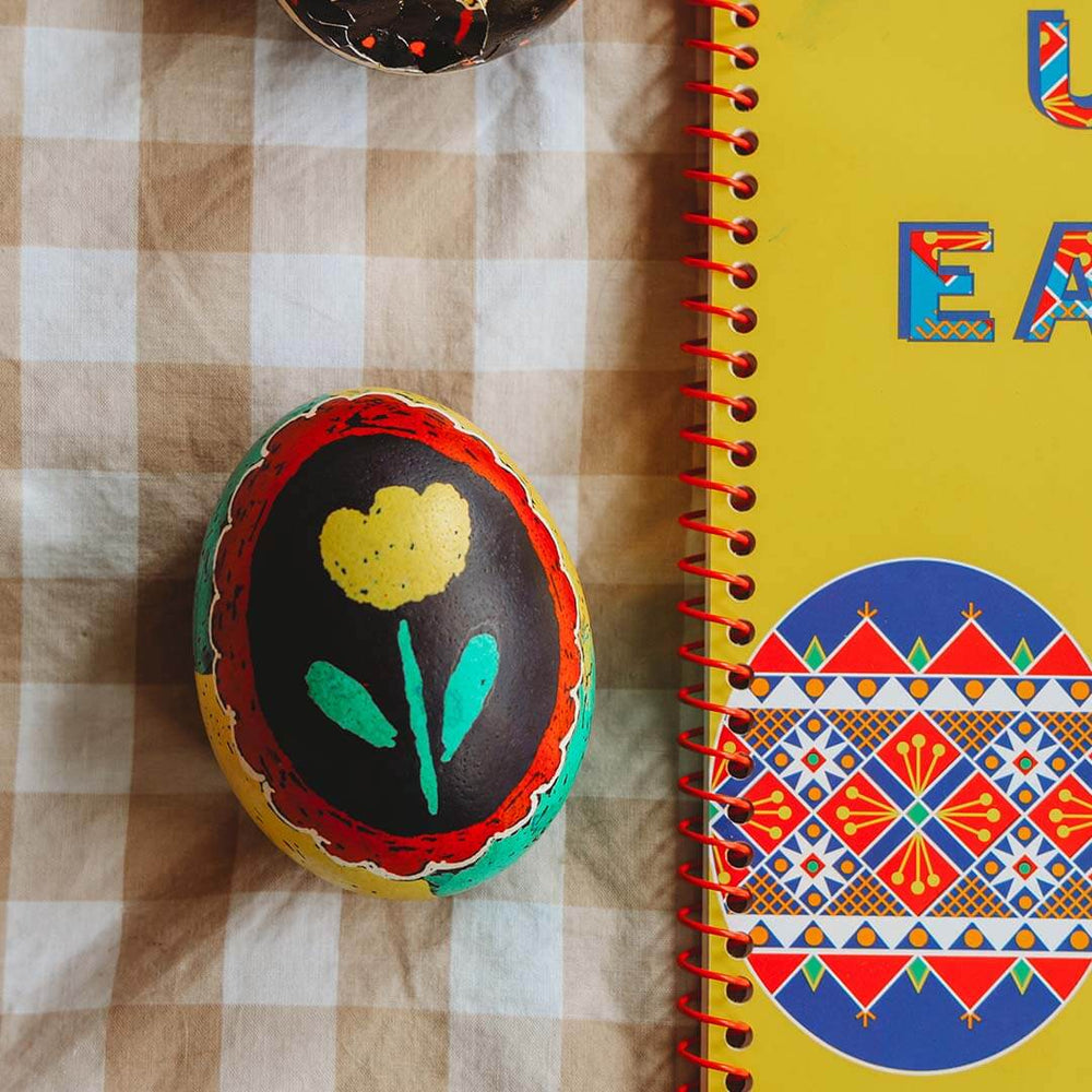 A Kid's Guide to Decorating Ukrainian Easter Eggs Kit with an egg with a tulip on it.