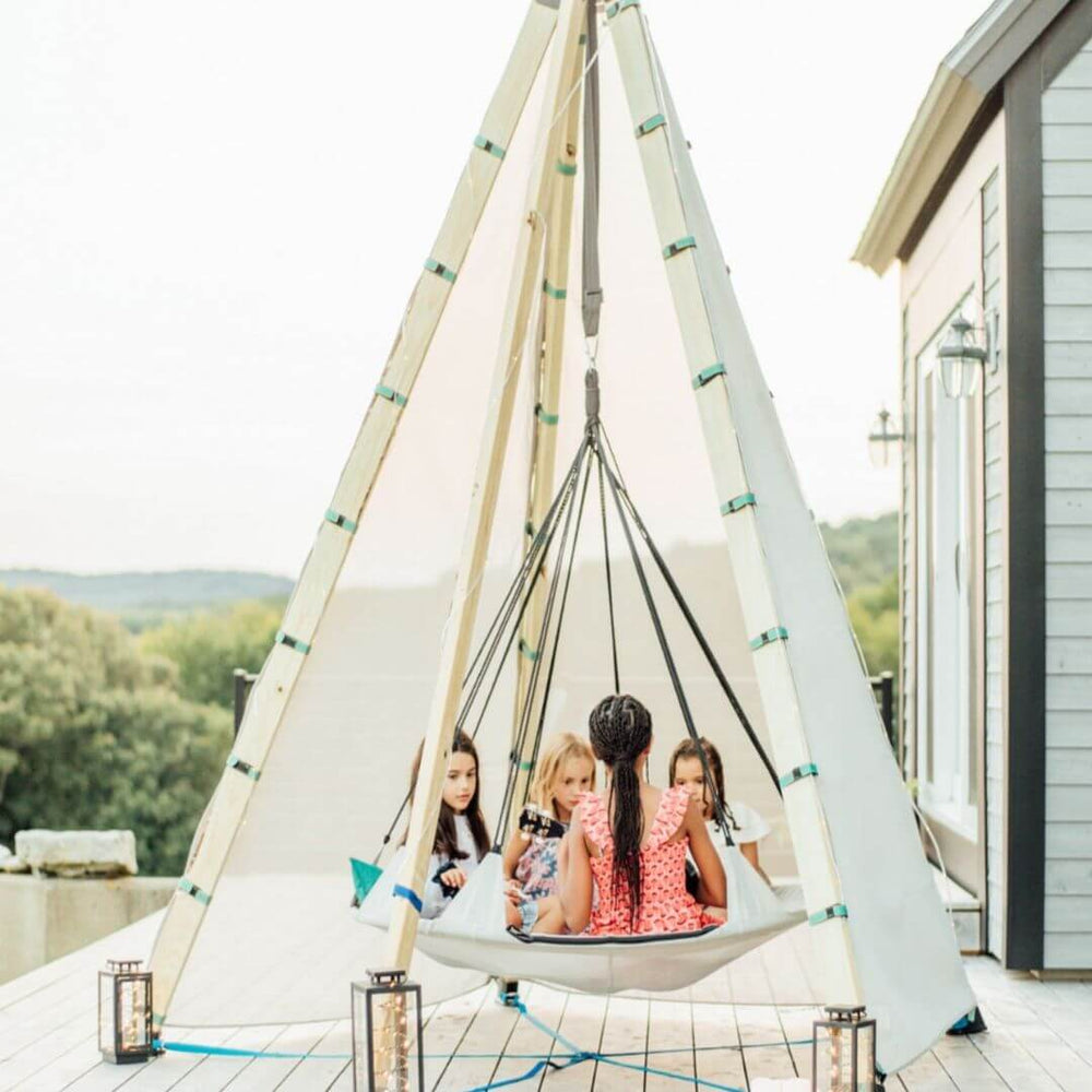 Bijou Build Nest structure and swing with 4 children sitting inside of it.