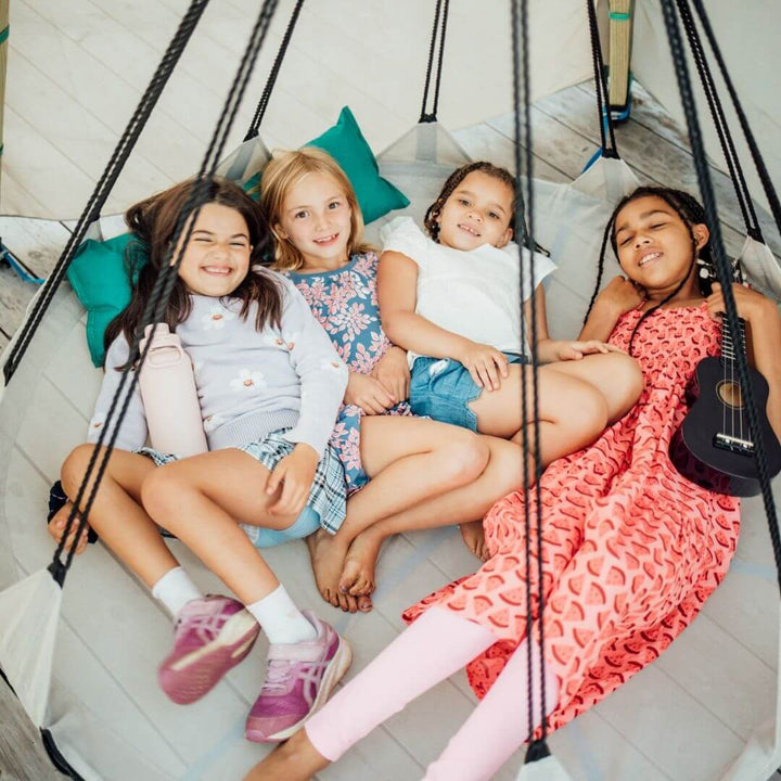 Bijou Build Nest outdoor shelter with suspended 5-foot Hover swing, UV-protective fabric canopy, solar LED lights, and cushions for relaxing outdoors - Bella Luna Toys
