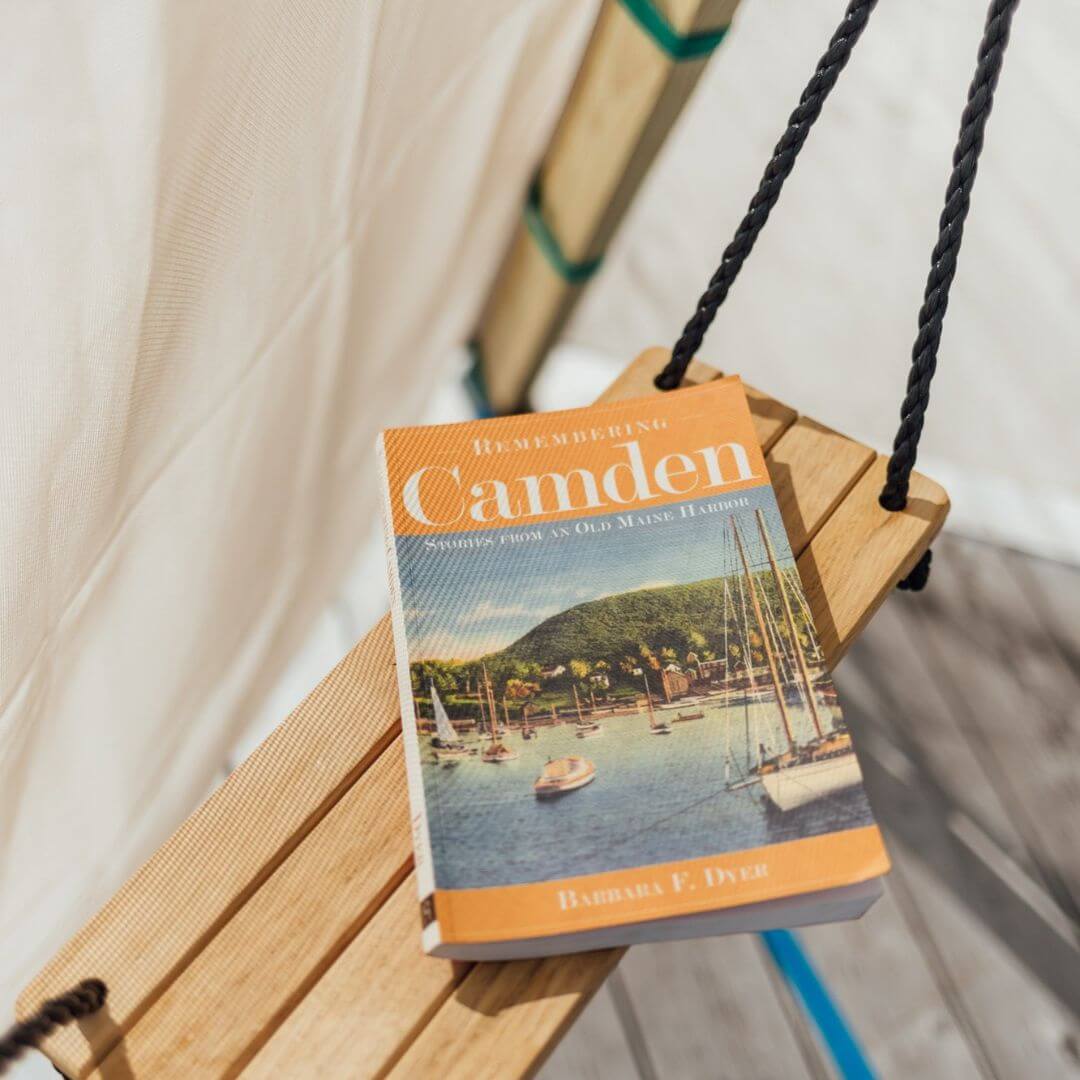 A book on top of the hanging Rest shelf inside of a Bijou Build play structure.