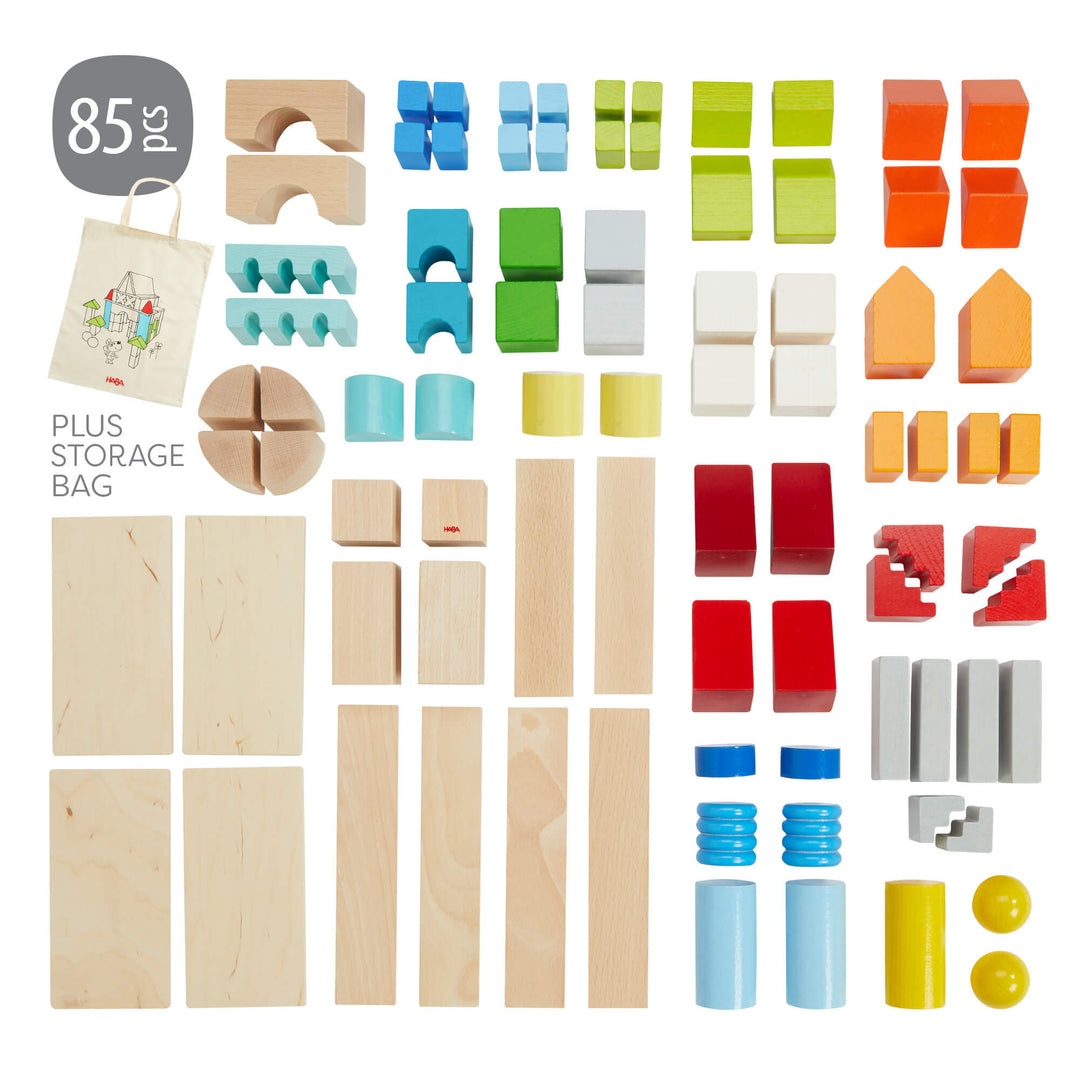 An assortment of 85 colorful wooden HABA building blocks in various shapes, with a storage bag included.