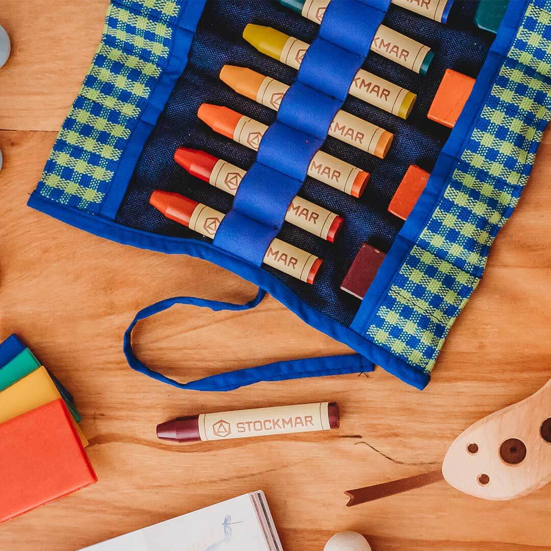 Set of Stockmar crayons in a blue case on a wooden surface
