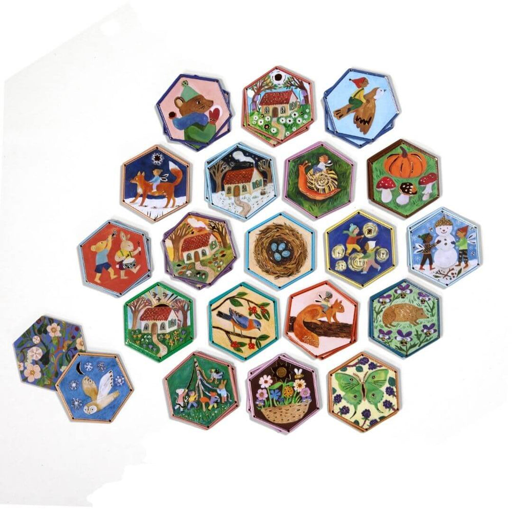 Hexagonal tiles with gold foil accents laid out on a white background showing the eeBoo Cottage Fairies Matching Game featuring whimsical fairy artwork by Gemma Koomen.