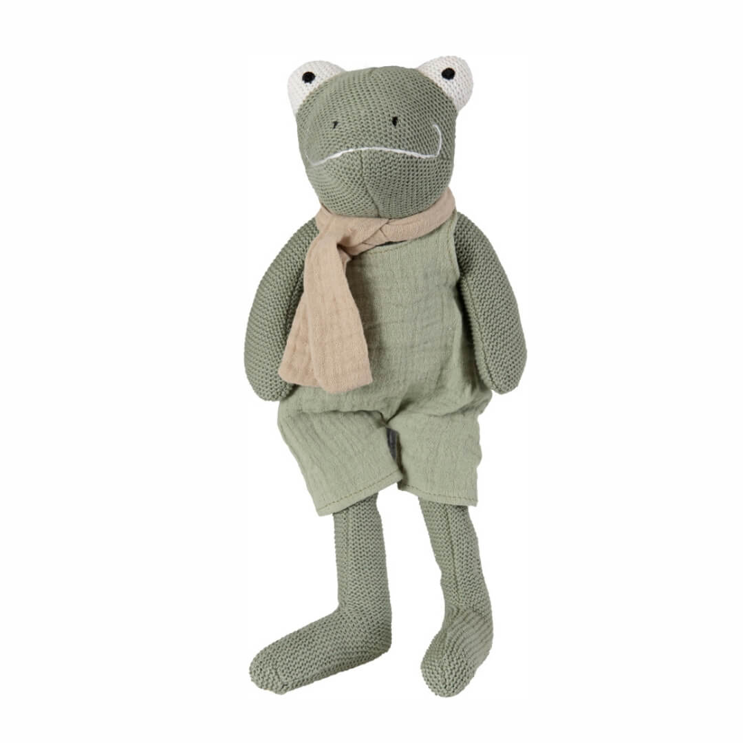 Soft knitted cotton Jeremy the frog toy from Egmont Toys with long limbs, a tan scarf, green overalls and a built-in rattle, designed for toddlers and young children shown against a white background.