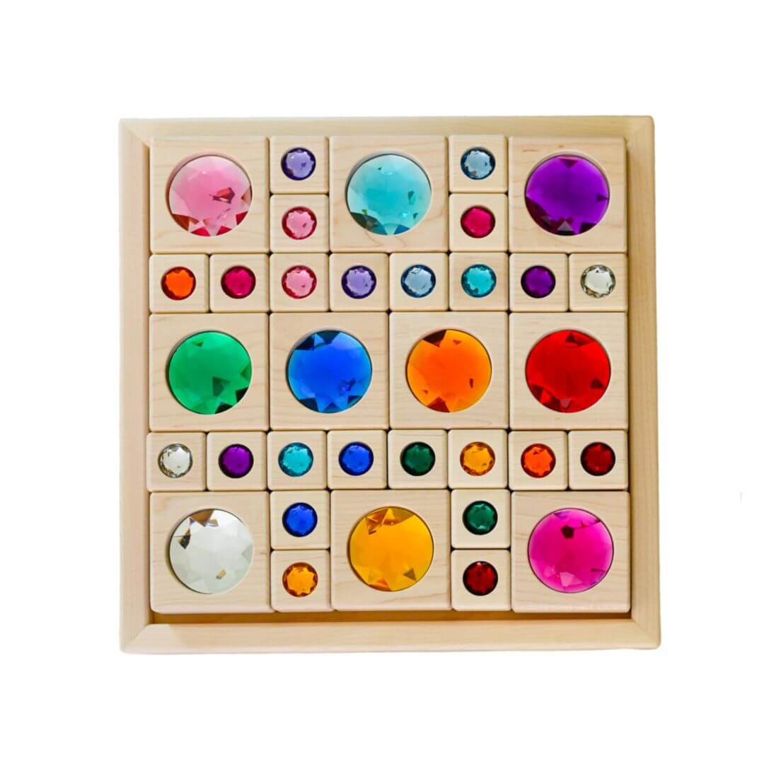 Colorful wooden block puzzle with embedded gems on a white background