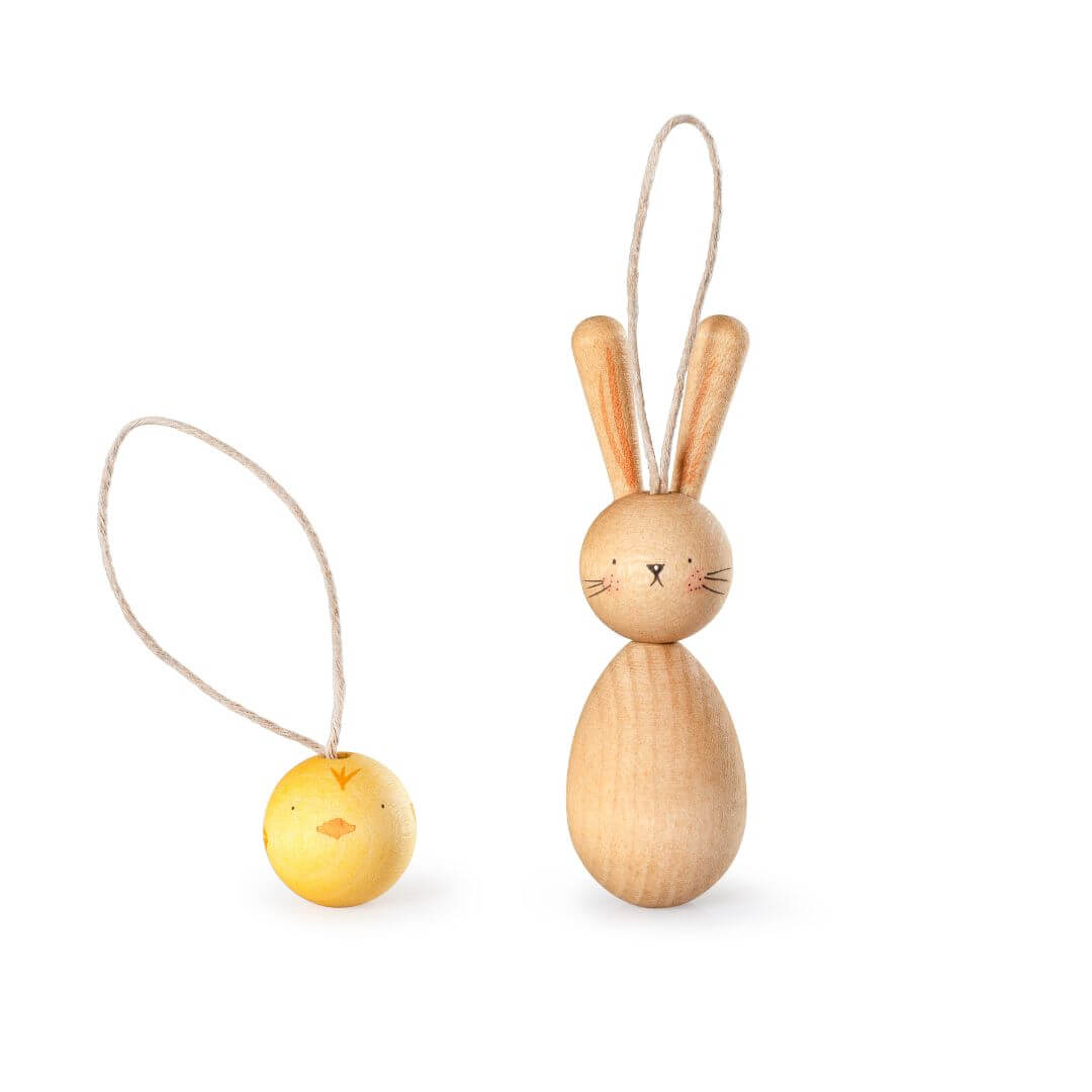 A set of two handcrafted wooden Easter ornaments from Grapat, featuring a small hand-painted yellow chick and a wooden bunny with long ears, both with natural wood finishes and simple, delicate facial details. Each ornament has a looped string attached for hanging, making them perfect for Easter decorations or gifts.