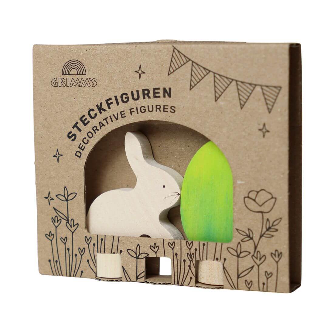 Grimm’s Wooden Easter Egg and Bunny in the green colorway, in the beautifully illustarted cardboard packaging that they arrive in.