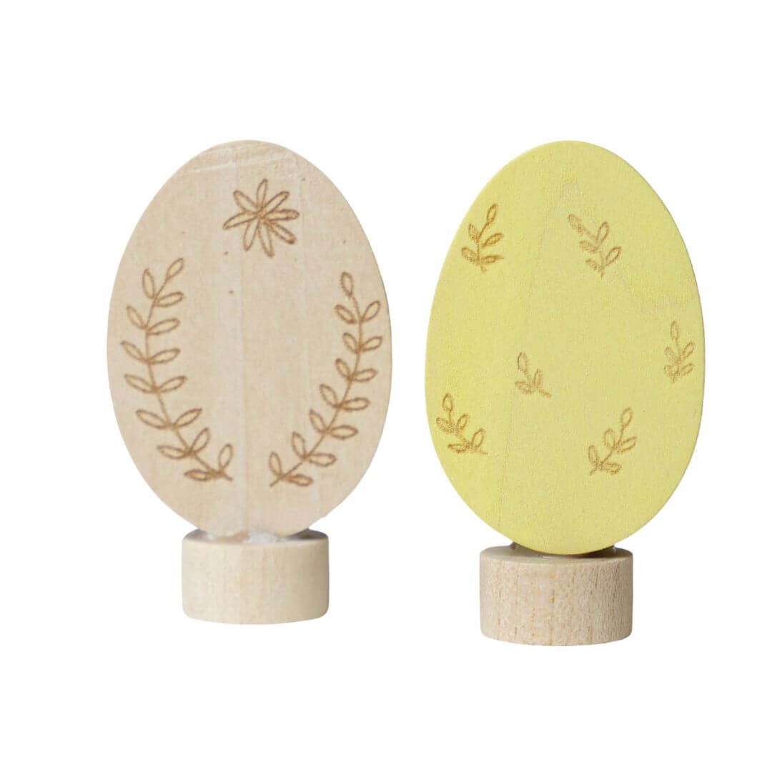 Grimm’s Wooden Easter Eggs in the Ornamental Colorway, showing the yellow and natural colors of the two eggs. 