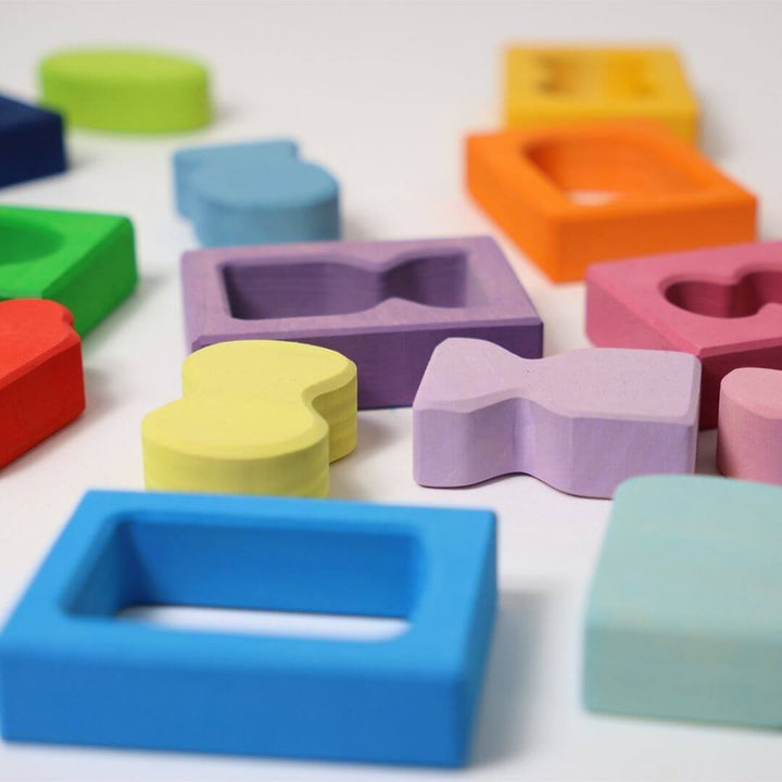 Close-up of Grimm’s Windows Wooden Building Set pieces in bright rainbow colors and varied window-like shapes, perfect for stacking and sorting. Bella Luna Toys 