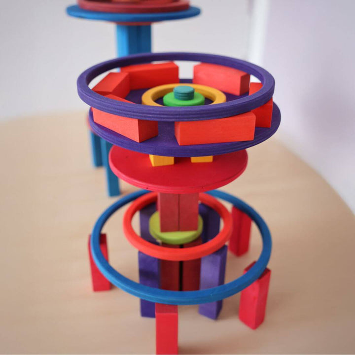 Colorful vertical tower structure built with Grimm’s Rainbow circles and rings and other blocks, demonstrating imaginative architectural play