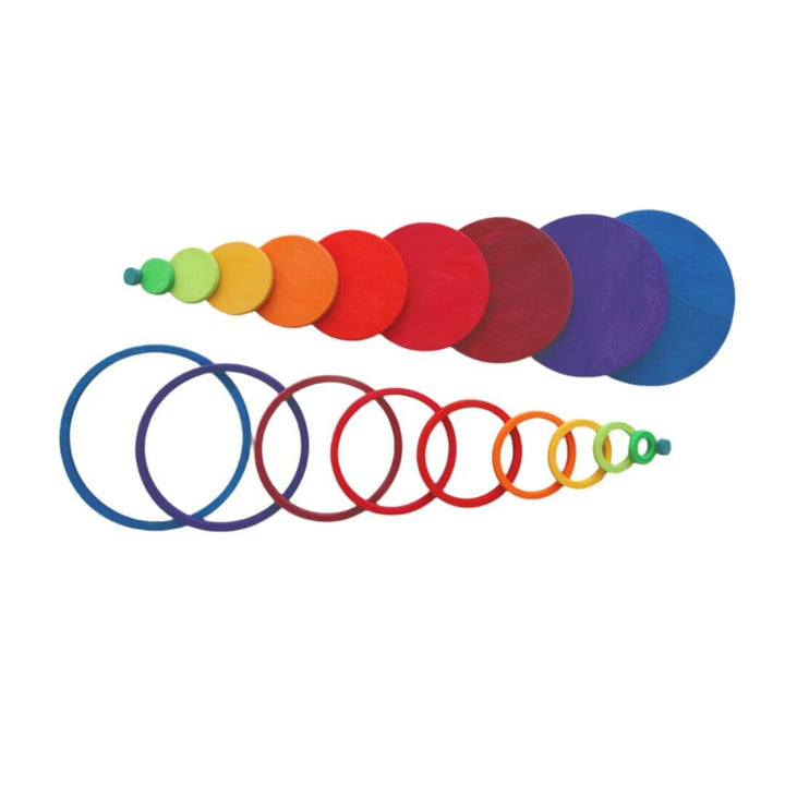 Grimm’s Rainbow Circles and Rings Set in rainbow colors arranged by size, showing solid wooden discs and matching open rings on a white background.