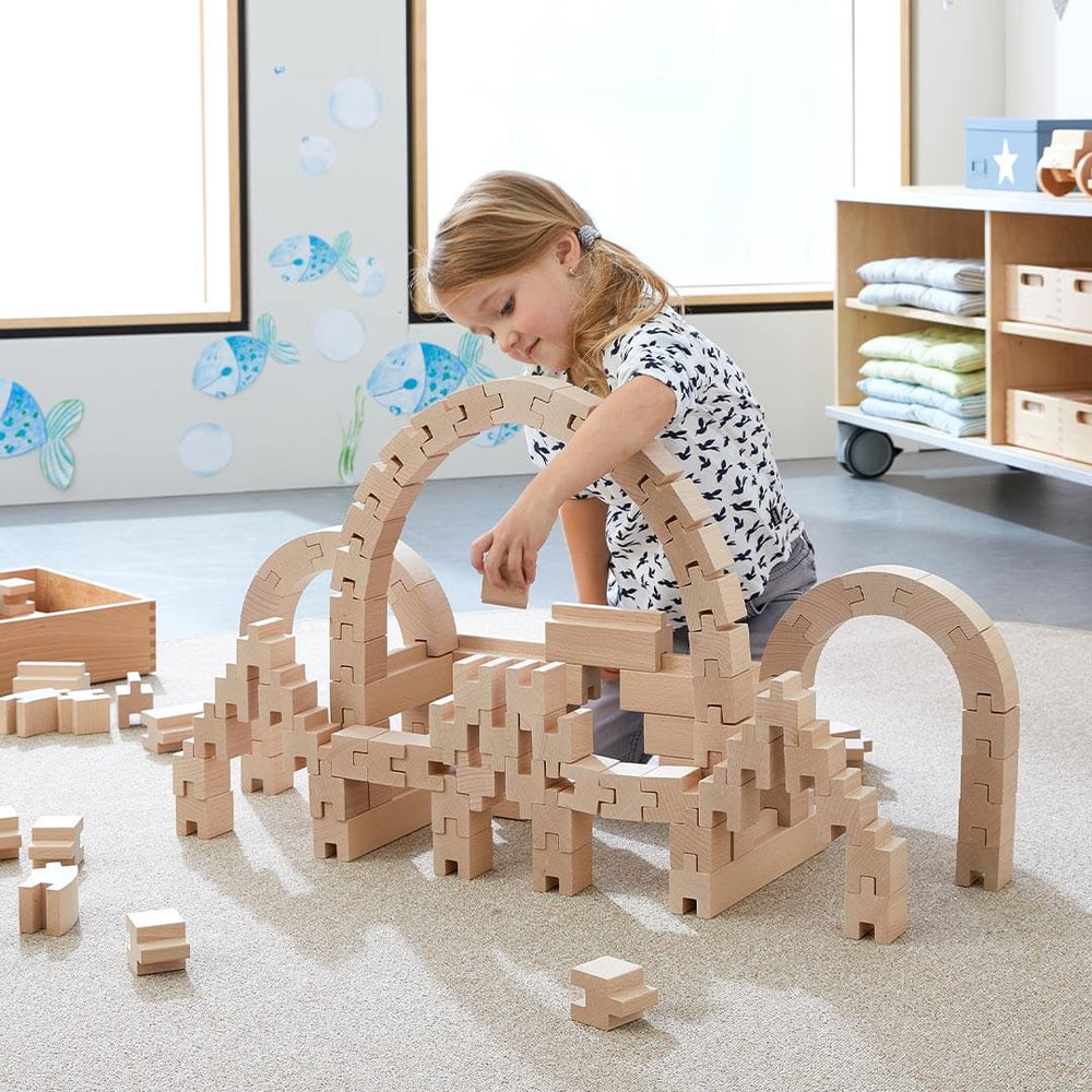 Child playing with HABA Interlocking Wooden Blocks Construction Set