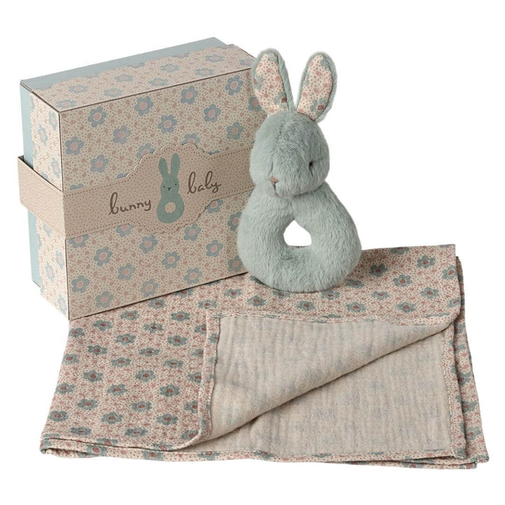 Maileg mint green rabbit rattle baby gift set with soft floral cloth and plush rabbit, packaged in a vintage-style gift box.