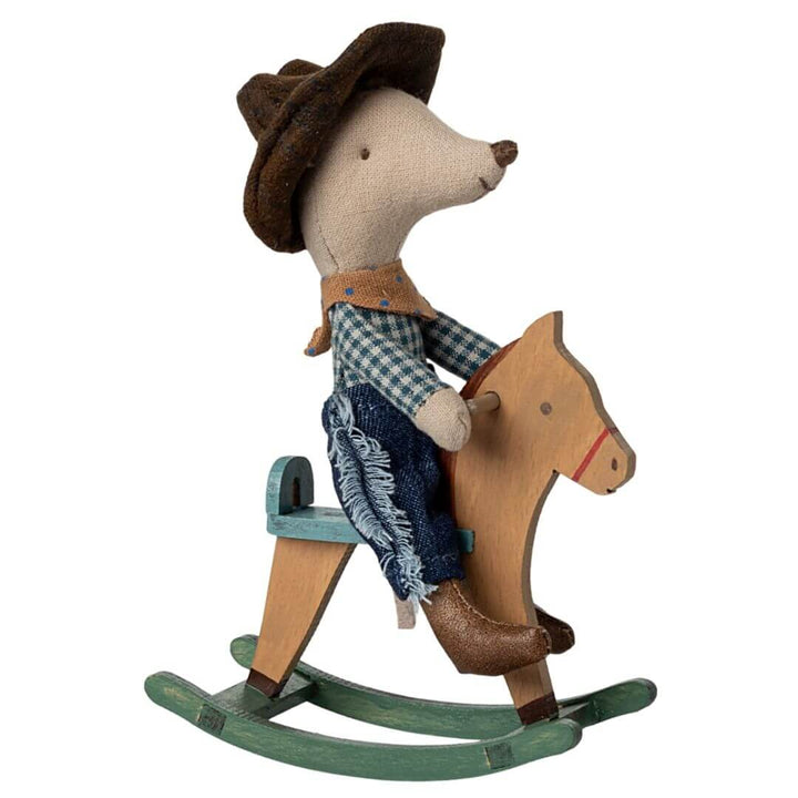 Maileg Little Brother Cowboy Mouse wearing jeans, a plaid shirt, scarf, and cowboy hat, sitting on a wooden rocking horse.