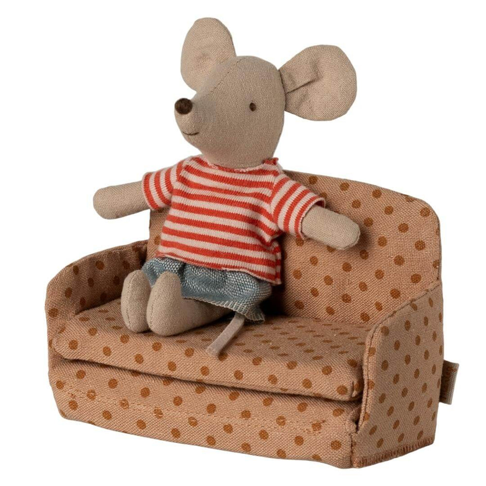 Maileg mouse-sized sofa bed in polka dot fabric, with a mouse in a striped shirt and skirt sitting on it from Bella Luna Toys.