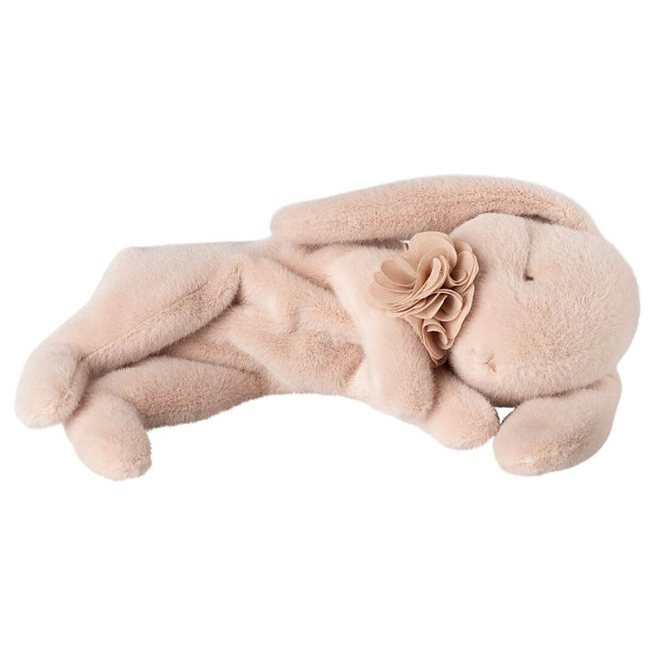 Soft pink Maileg sleeping bunny plush with closed eyes and a delicate chiffon flower collar, lying on its side.