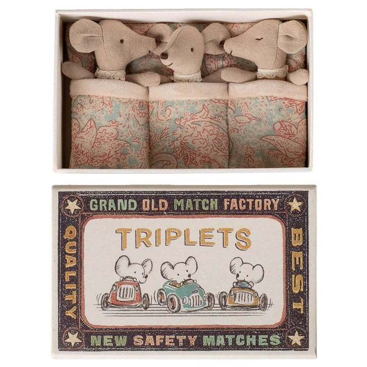 Maileg - Three Maileg baby mice triplets wearing pastel striped pajamas tucked inside a vintage-style matchbox bed with patterned bedding and illustrated matchbox cover - Bella Luna Toys