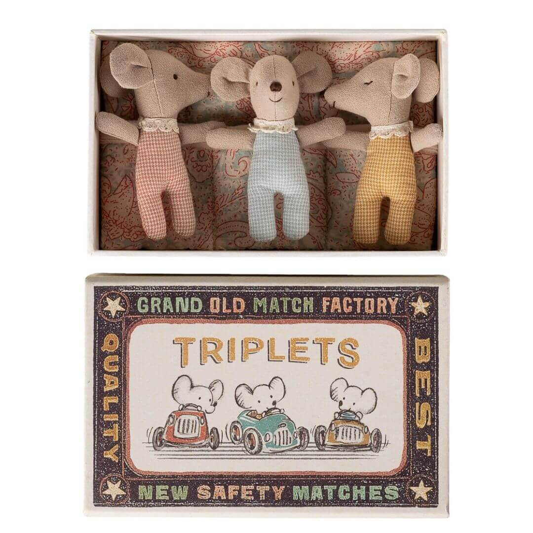 Maileg - Three Maileg baby mice triplets wearing pastel striped pajamas tucked inside a vintage-style matchbox bed with patterned bedding and illustrated matchbox cover - Bella Luna Toys