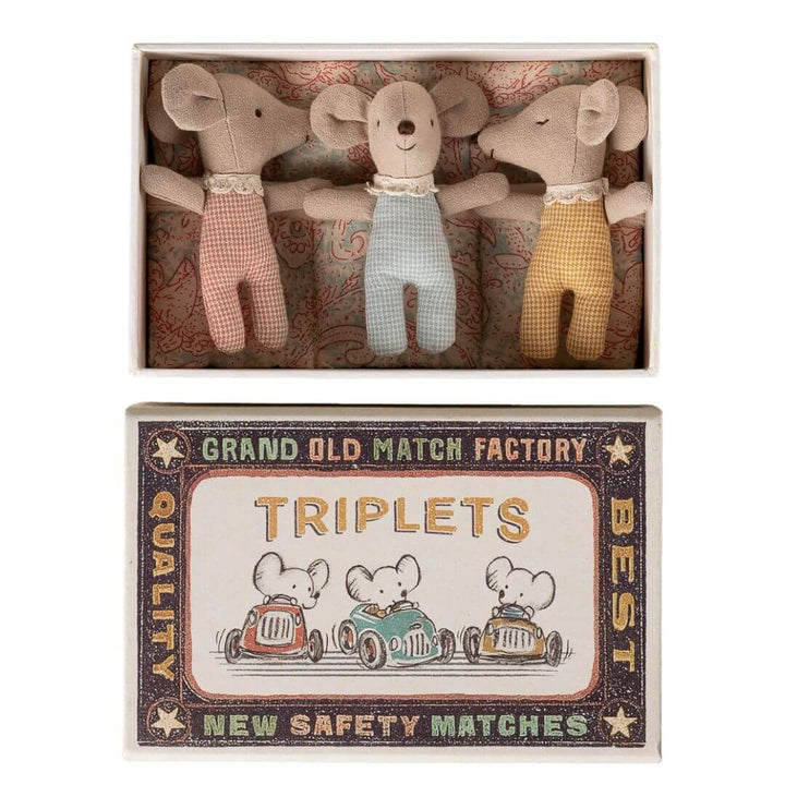 Maileg - Three Maileg baby mice triplets wearing pastel striped pajamas tucked inside a vintage-style matchbox bed with patterned bedding and illustrated matchbox cover - Bella Luna Toys