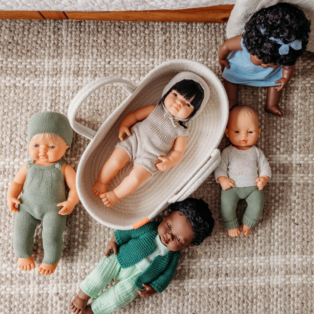 Set of dolls in various outfits on a textured surface