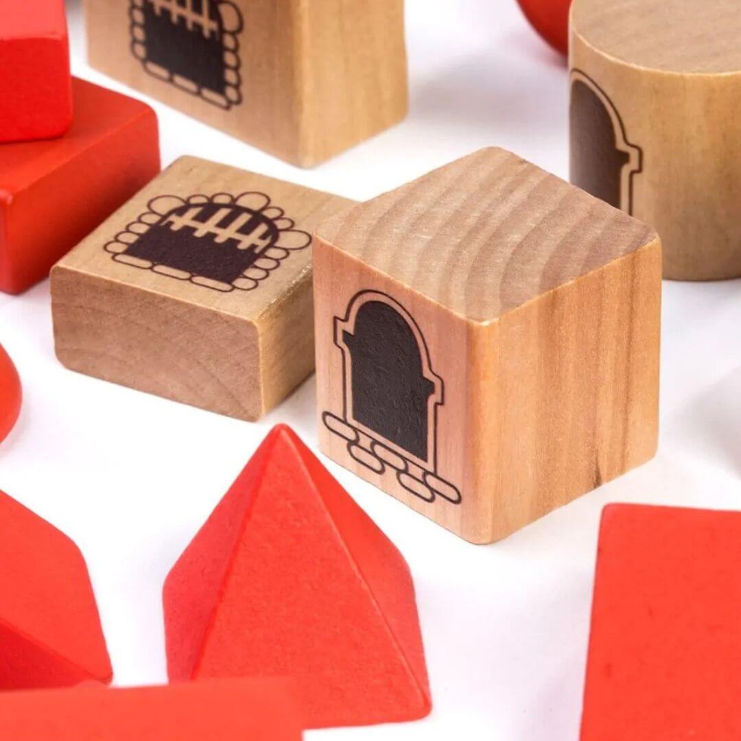 Miniland - A close up view of the wooden castle building block set made from sustainable wood, featuring natural and red architectural blocks arranged into a large castle with towers, arches, staircases, and turrets - Bella Luna Toys