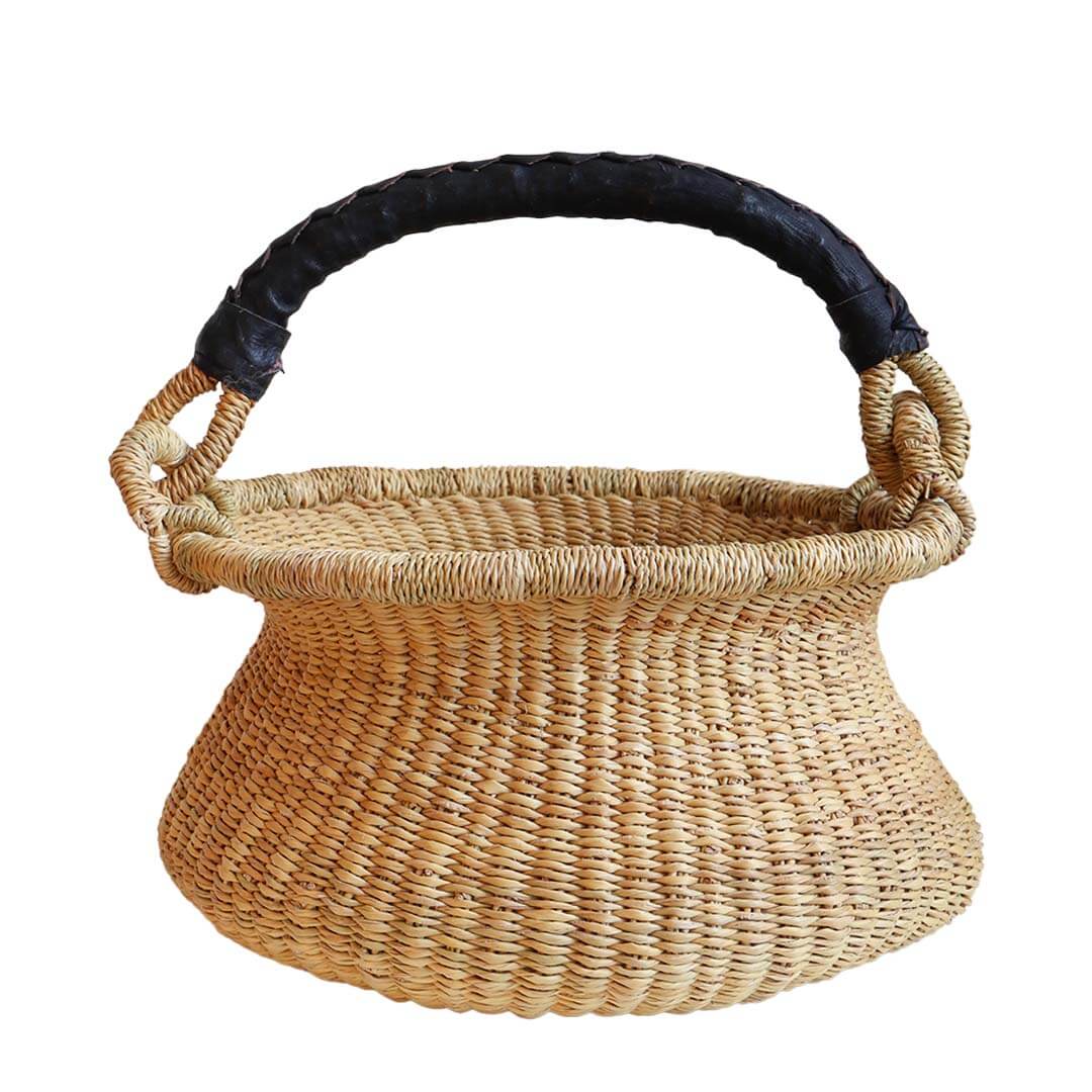 Woven basket with a black handle on a white background