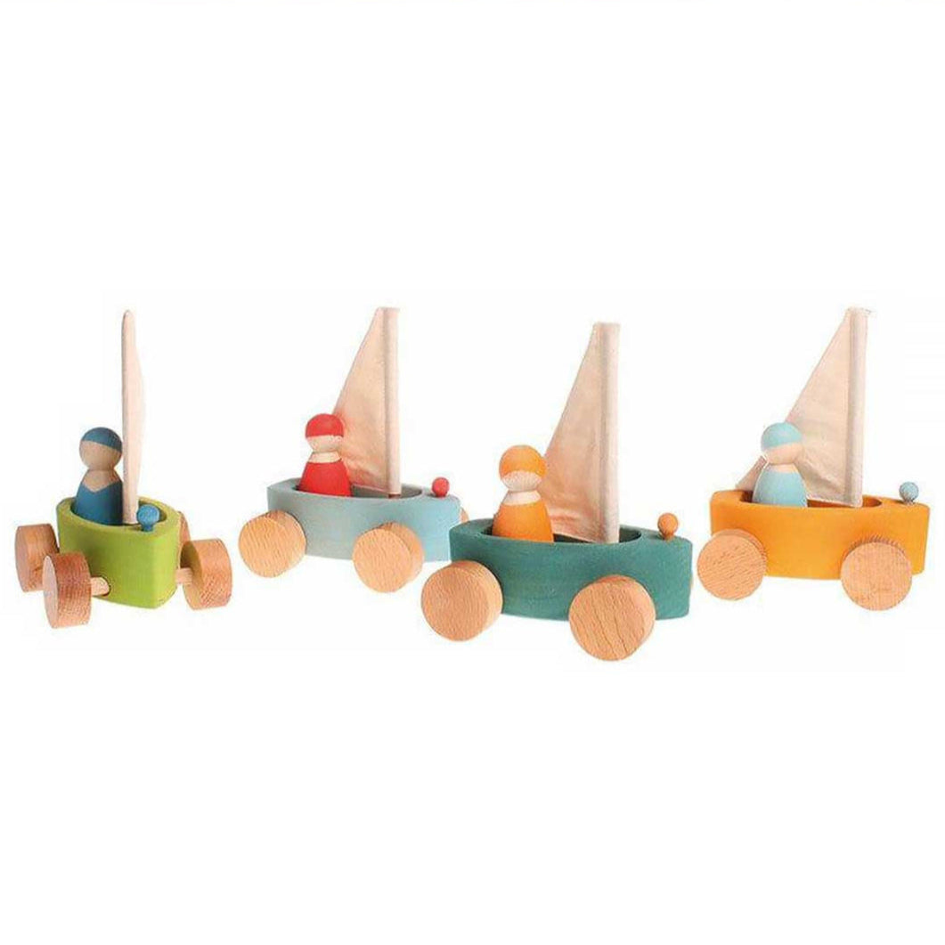 Set of colorful wooden toy boats on a white background