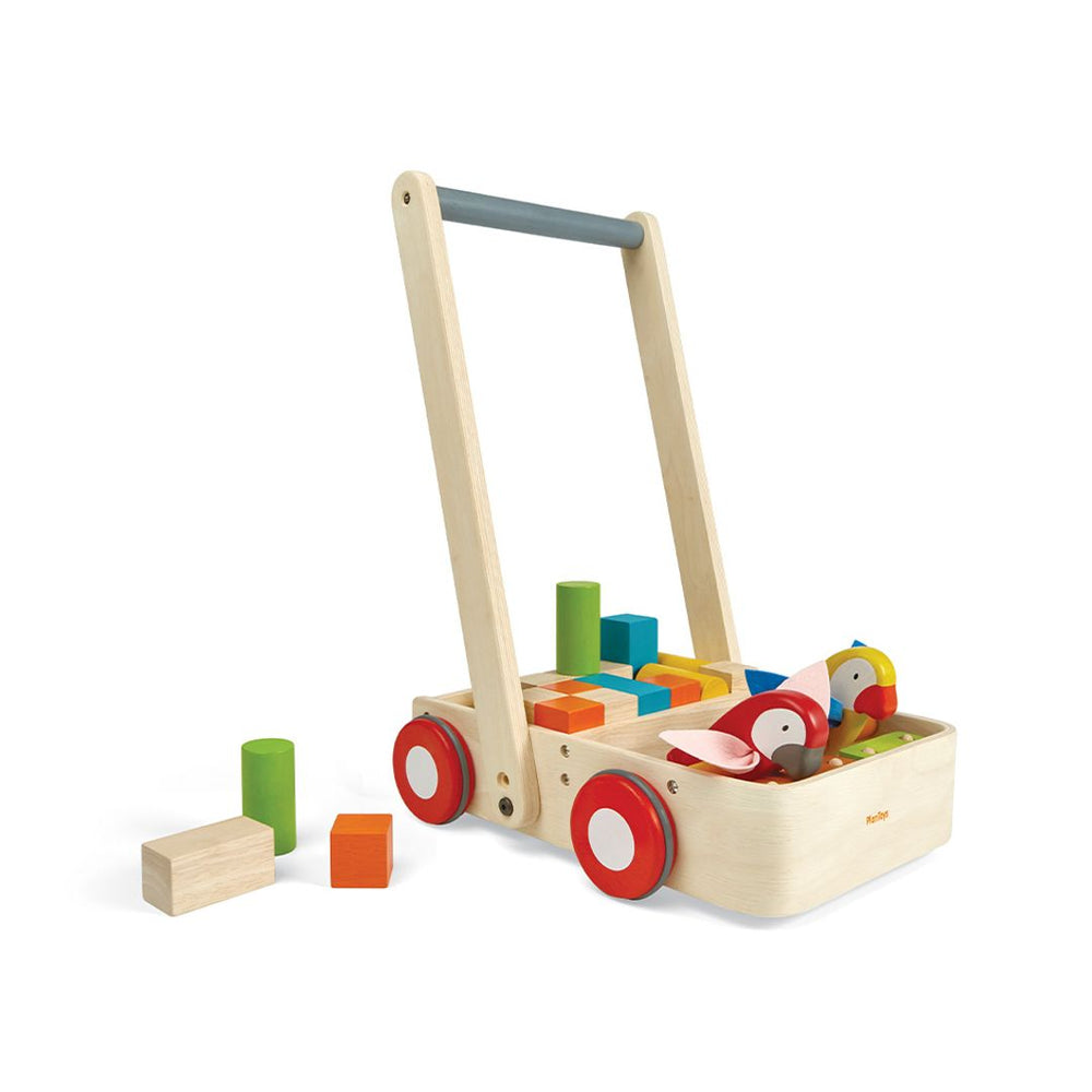 A front view of the PlanToys Wooden Bird Walker Wagon, a push toy with two wooden birds, 10 colorful blocks, 6 natural blocks, and a sturdy handle for early walkers showing a few blocks next to it. 