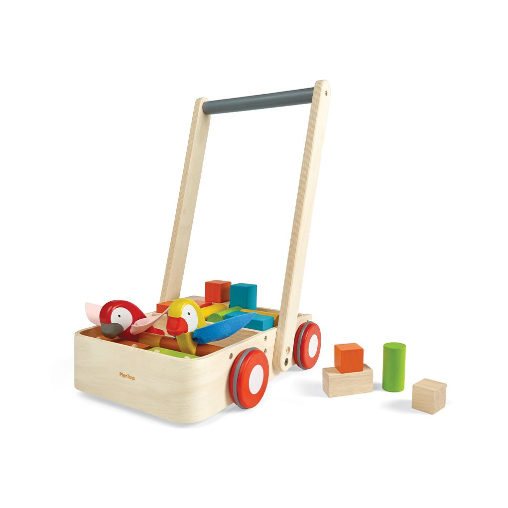 PlanToys Wooden Bird Walker Wagon, a push toy with two wooden birds, 10 colorful blocks, 6 natural blocks, and a sturdy handle for early walkers shown with a few blocks next to it.