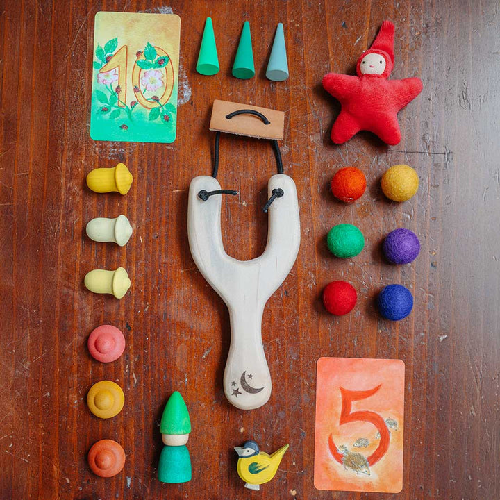 Collection of colorful toys and game pieces on a wooden surface