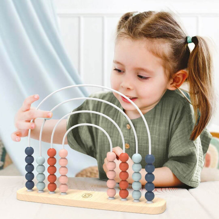 A child moved a bead across the rainbow abacus from Speedy Monkey.