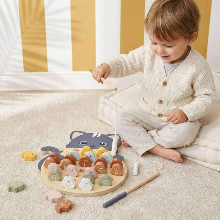 A child catching a fish in the Speedy Monkey  Wooden Alphabet Fishing Game.