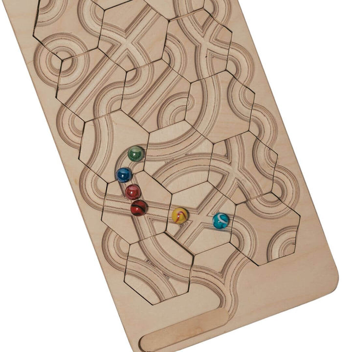 Close up of the wooden marble maze game board with rearrangeable hexagon tiles and colorful marbles, designed for puzzle-solving, marble racing, and open-ended track building - Bella Luna Toys