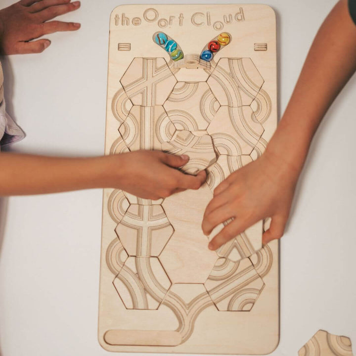 2 children playing with the wooden marble maze game board with rearrangeable hexagon tiles and colorful marbles - Bella Luna Toys