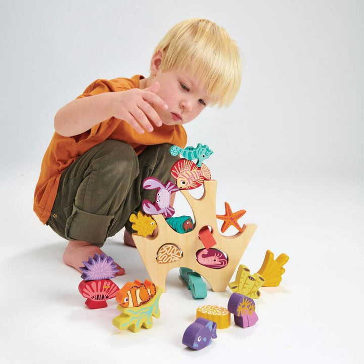 Child stacking sea creatures from the Tender Leaf Toyrs Stacking Coral Reef.