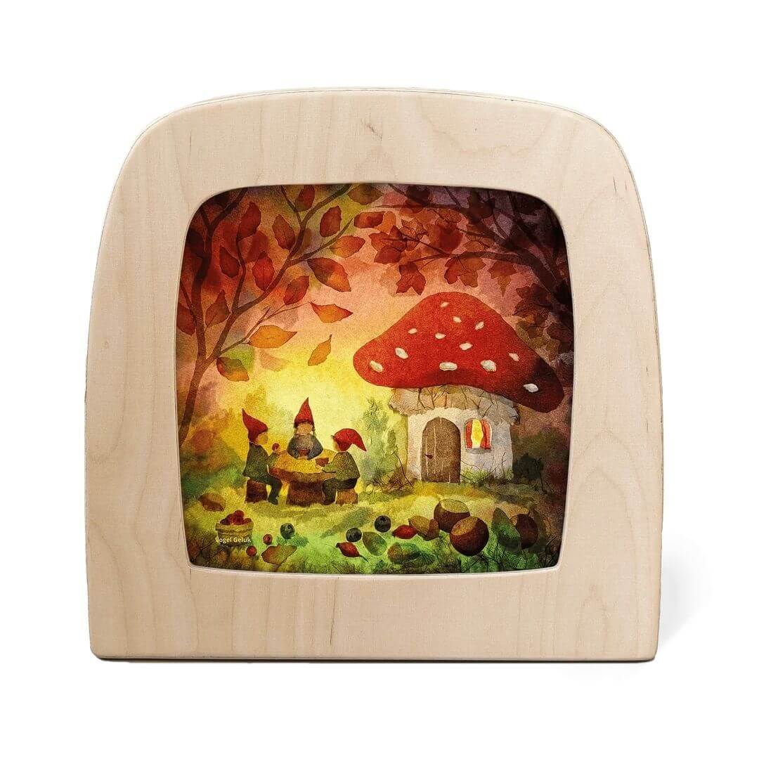 Toverlux Lamp Transparency – “Gnome Picnic” by Vogel Geluk, depicting gnomes gathered around a table beneath a toadstool cottage surrounded by autumn leaves and forest treasures- Bella Luna Toys