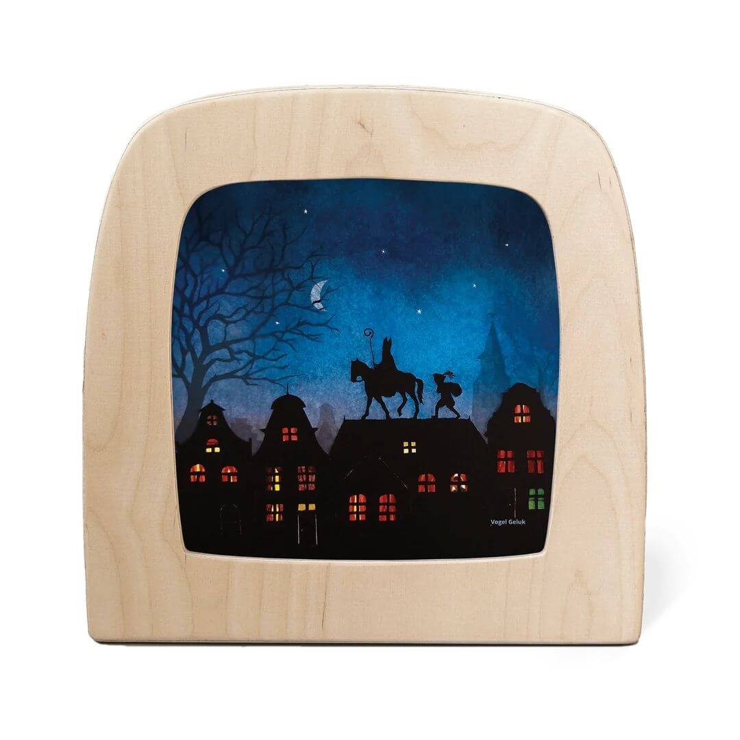 Toverlux Lamp Transparency – “Saint Nicholas” by Vogel Geluk, depicting Saint Nicholas and his helper traveling across rooftops under a starry blue sky with warmly lit windows below - Bella Luna Toys