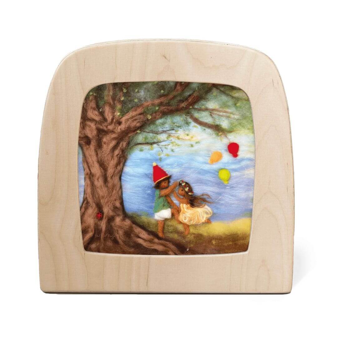 Toverlux Magic Lamp Night Light Silhouette featuring two felted children in seasonal celebration under a large tree with colorful balloons and flowing garments.