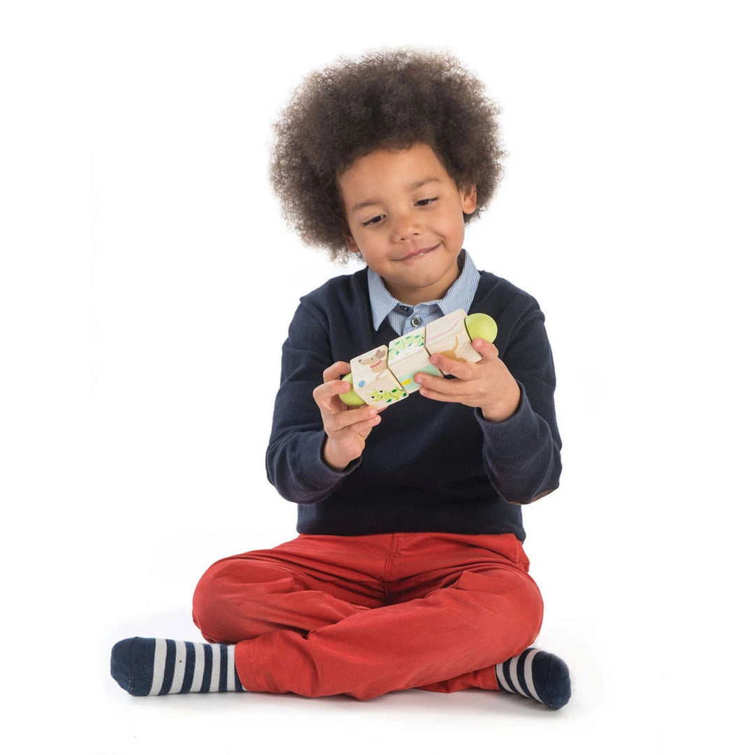 Child sitting on the ground playing with the twisting cubes- Bella Luna Toys
